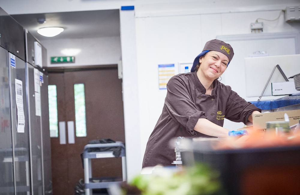 Chef smiling working in kitchen