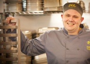 Chef smiling working in kitchen