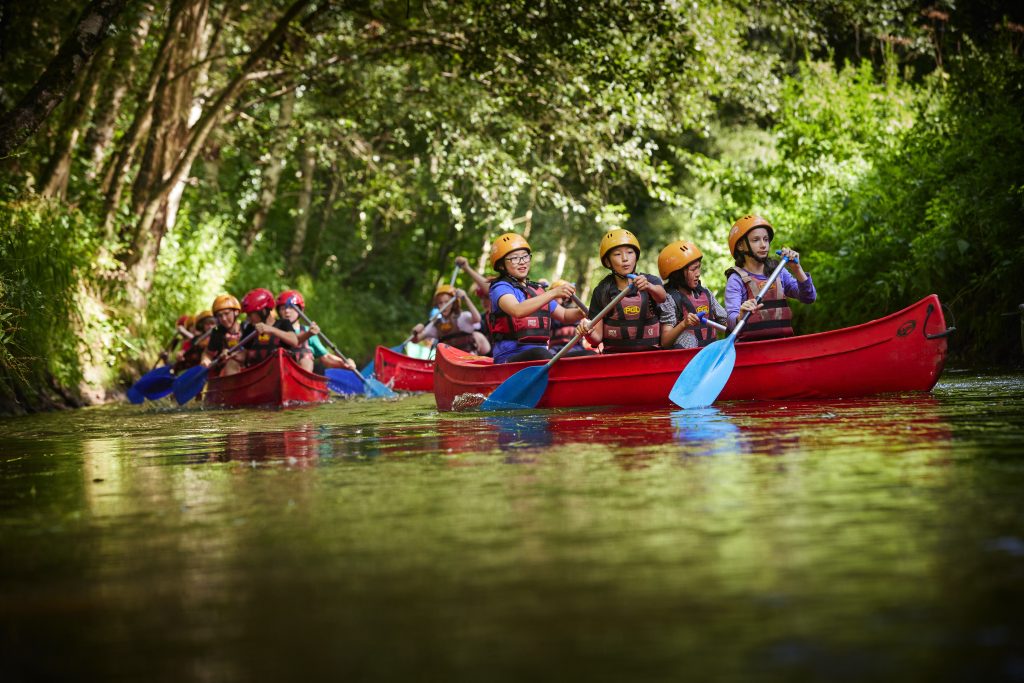 Children canoeing at PGL