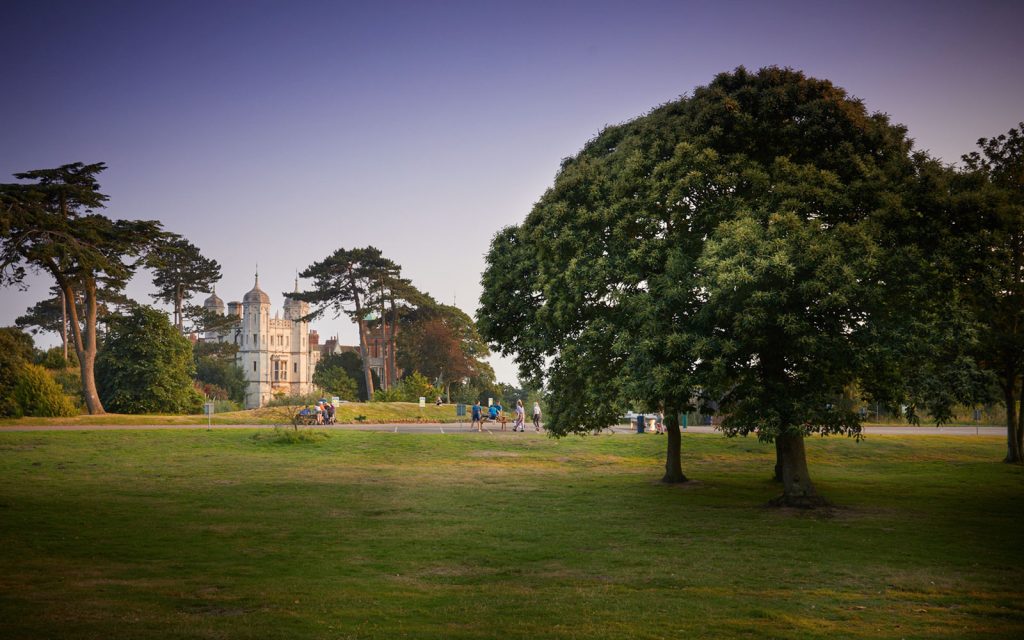 The grounds of PGL Bawdsey Manor with trees and a large mansion house.