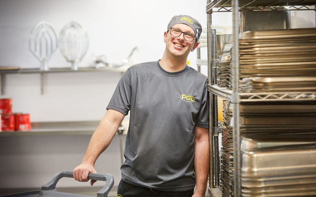 Smiling Catering Assistant in PGL uniform