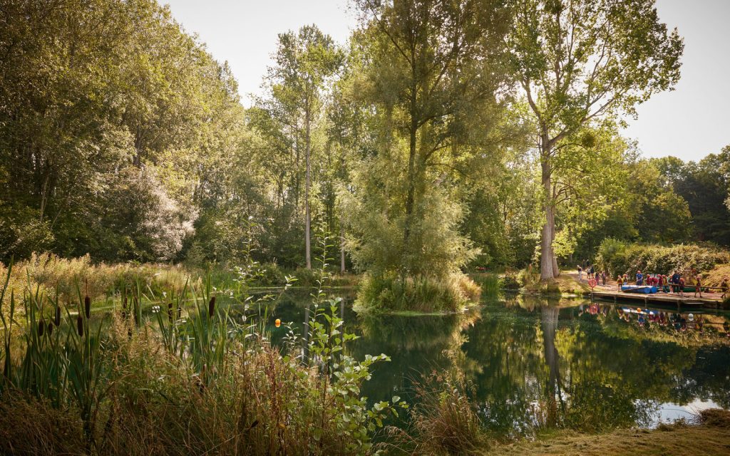 The lake at Tregoyd House. In the distance a PGL instructor is doing a raft building activity with a group of children