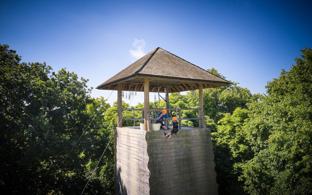 Boy abseiling helped by Instructor